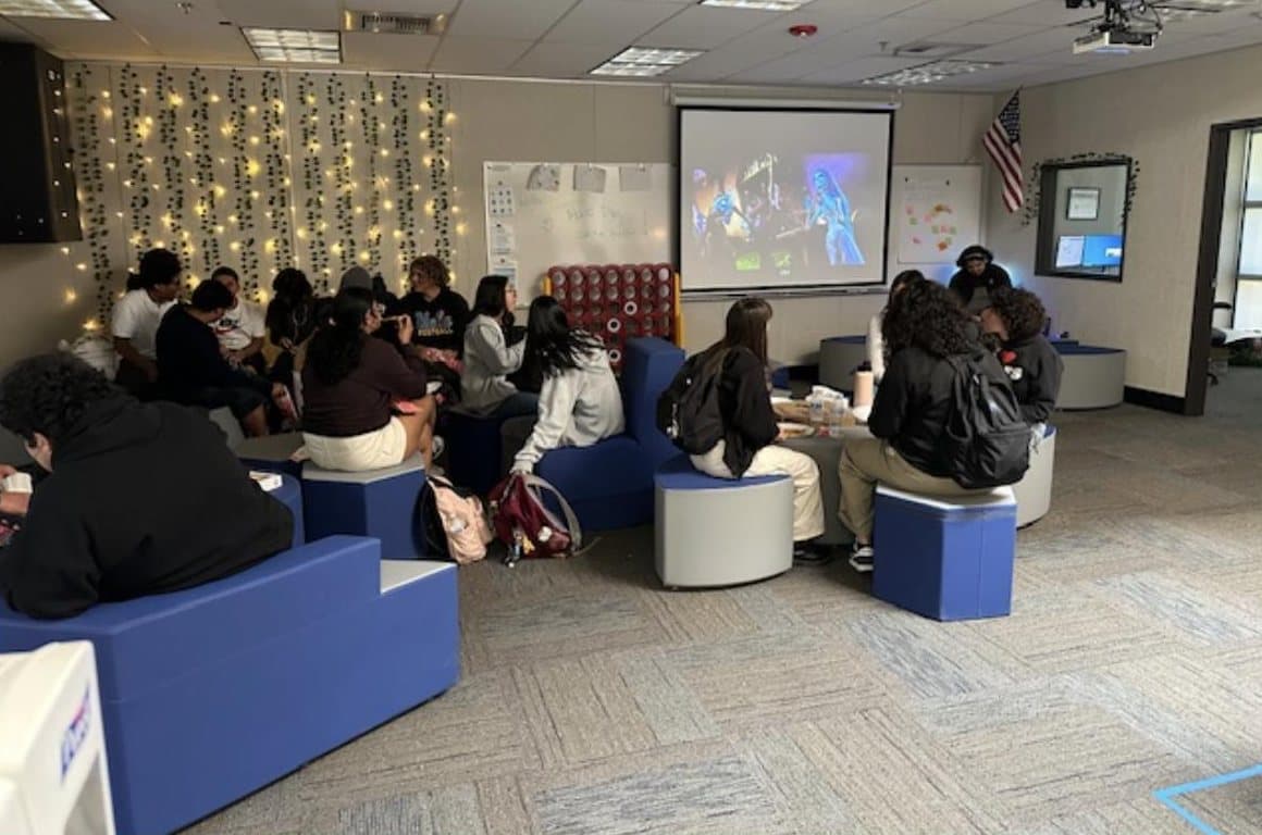Students hanging out together in the Wellness Center during a movie.