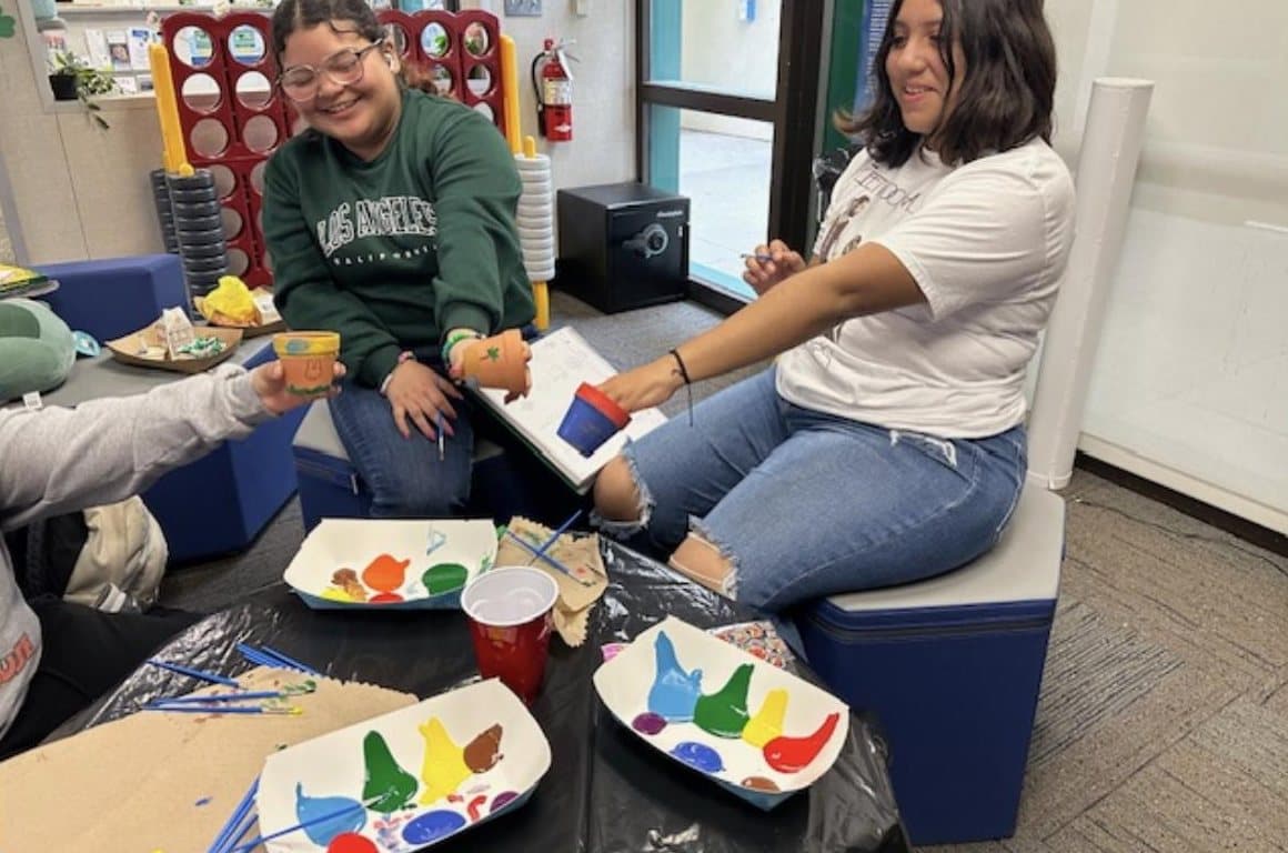 Students painting flower pots at a craft session in the Wellness Center.